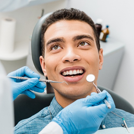 a man having his mouth examined by a dentist