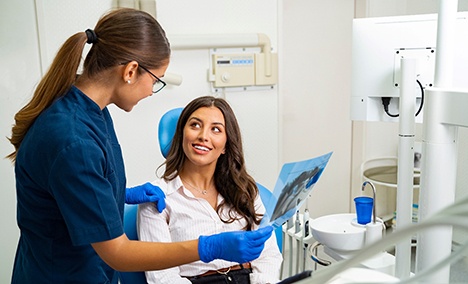 a dentist showing a patient their X-rays