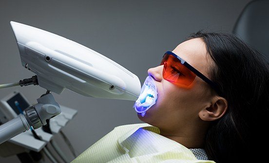 Woman receiving teeth whitening treatment