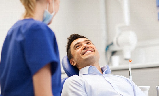 Patient smiling at his emergency dentist in Clinton Township