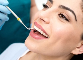 Woman receiving a dental checkup from a dentist