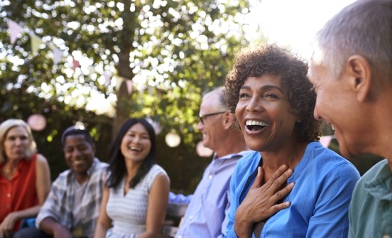 Group of friends laughing together outdoors