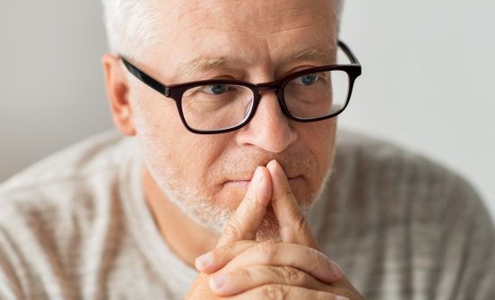 Man with glasses thinking