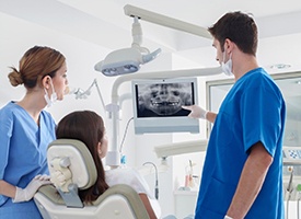 dentist showing a patient her dental X-rays 