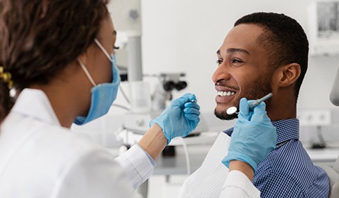 a dental hygienist cleaning a patients’ teeth