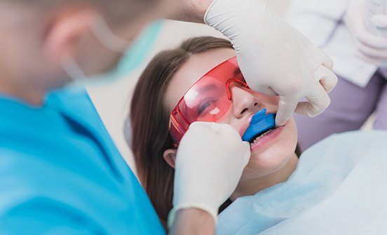 Young woman receiving fluoride treatment