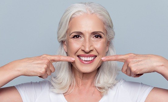 Woman pointing to beautiful smile