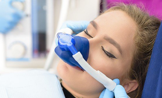 Woman with nitrous oxide nose mask