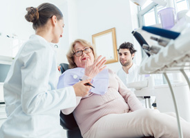 a patient consulting with her dentist about getting dental implants