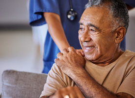 a person putting their hand on the shoulder of a smiling man