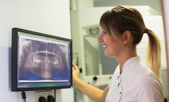 Dental team member looking at digital x-rays