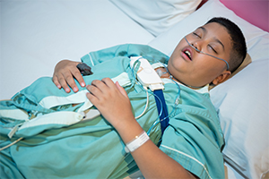 child wearing sleep apnea device