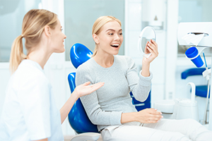 woman looking in mirror and smiling