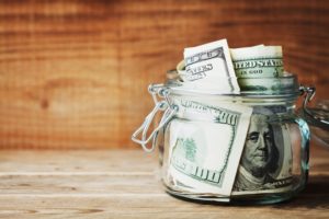 a jar full of money to signify savings