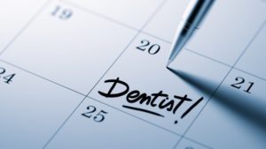 a calendar with a dental appointment reminder on it