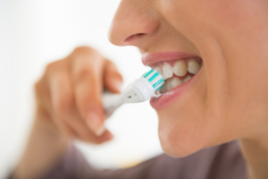 a woman brushing her teeth